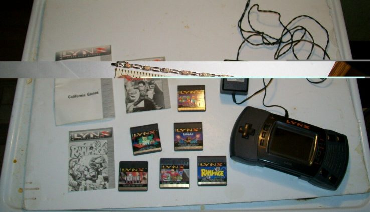 VINTAGE ATARI LYNX SYSTEM WITH 6 GAMES, BOOKS, & POWER CORD
