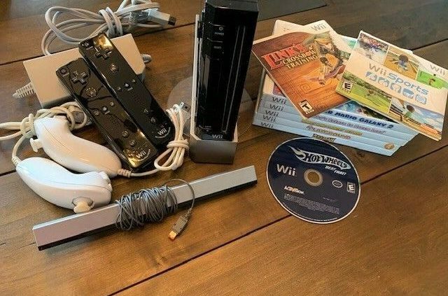 Nintendo WII with 2 controls ,2 nunchuks ,sensor and 6 games