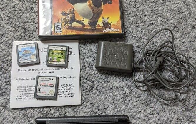 Nintendo DS Lite Shadowy w/ charger and 4 video games. Tested and working.