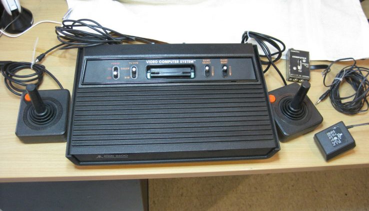 Vintage Atari 2600 Game Console with 2 joysticks and 7 video games